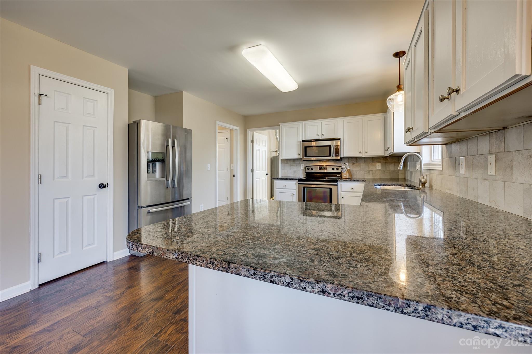 573 Strathclyde Way Rock Hill, SC 29730 - Photo 9 of 21 a kitchen with stainless steel appliances granite countertop a sink a stove and a wooden floors