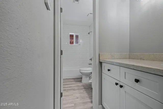 a bathroom with a sink and mirror with shower