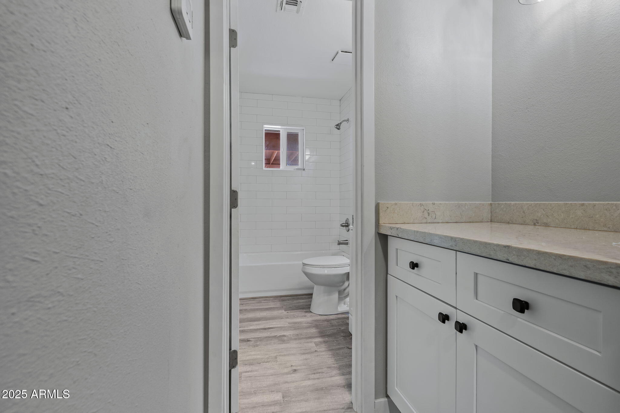 1940 West Amelia Avenue, Unit 1942 5 Phoenix, AZ 85015 - Photo 13 of 18 a bathroom with a granite countertop toilet and a sink