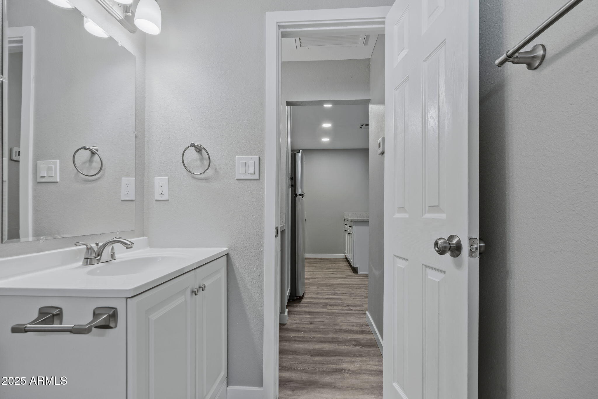 1940 West Amelia Avenue, Unit 1942 5 Phoenix, AZ 85015 - Photo 14 of 18 a bathroom with a sink and mirror with shower