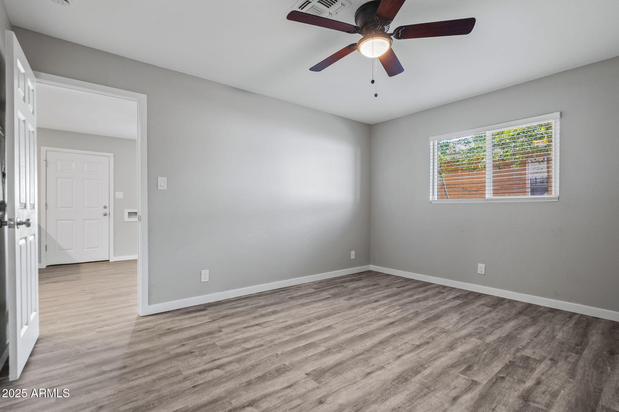 1940 West Amelia Avenue, Unit 1942 5 Phoenix, AZ 85015 - Photo 16 of 18 wooden floor in an empty room with a window
