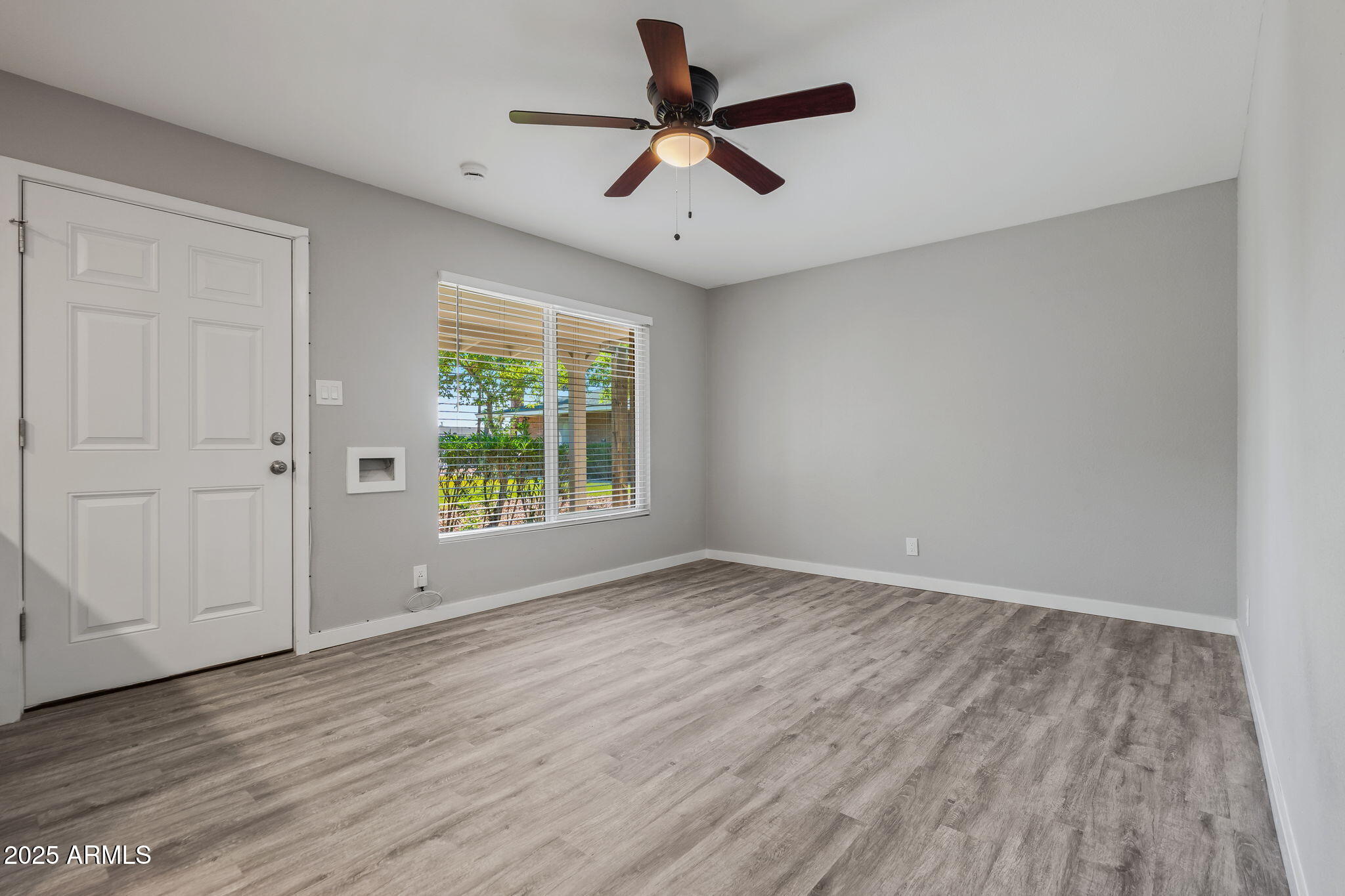 1940 West Amelia Avenue, Unit 1942 5 Phoenix, AZ 85015 - Photo 7 of 18 a view of room with window ceiling fan and hardwood floor