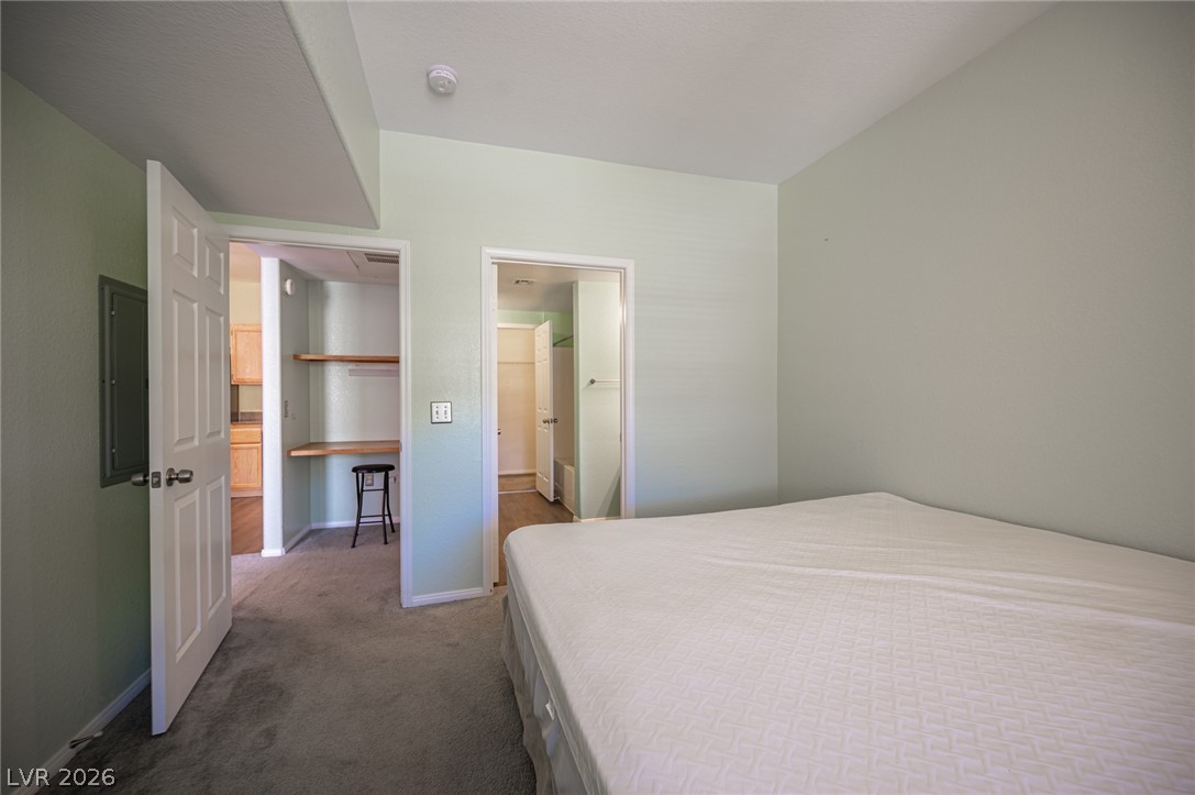 10550 West Alexander Road, Unit 2014 Las Vegas, NV 89129 - Photo 30 of 43 Plush carpeting and smooth walls define this comfortable bedroom space.