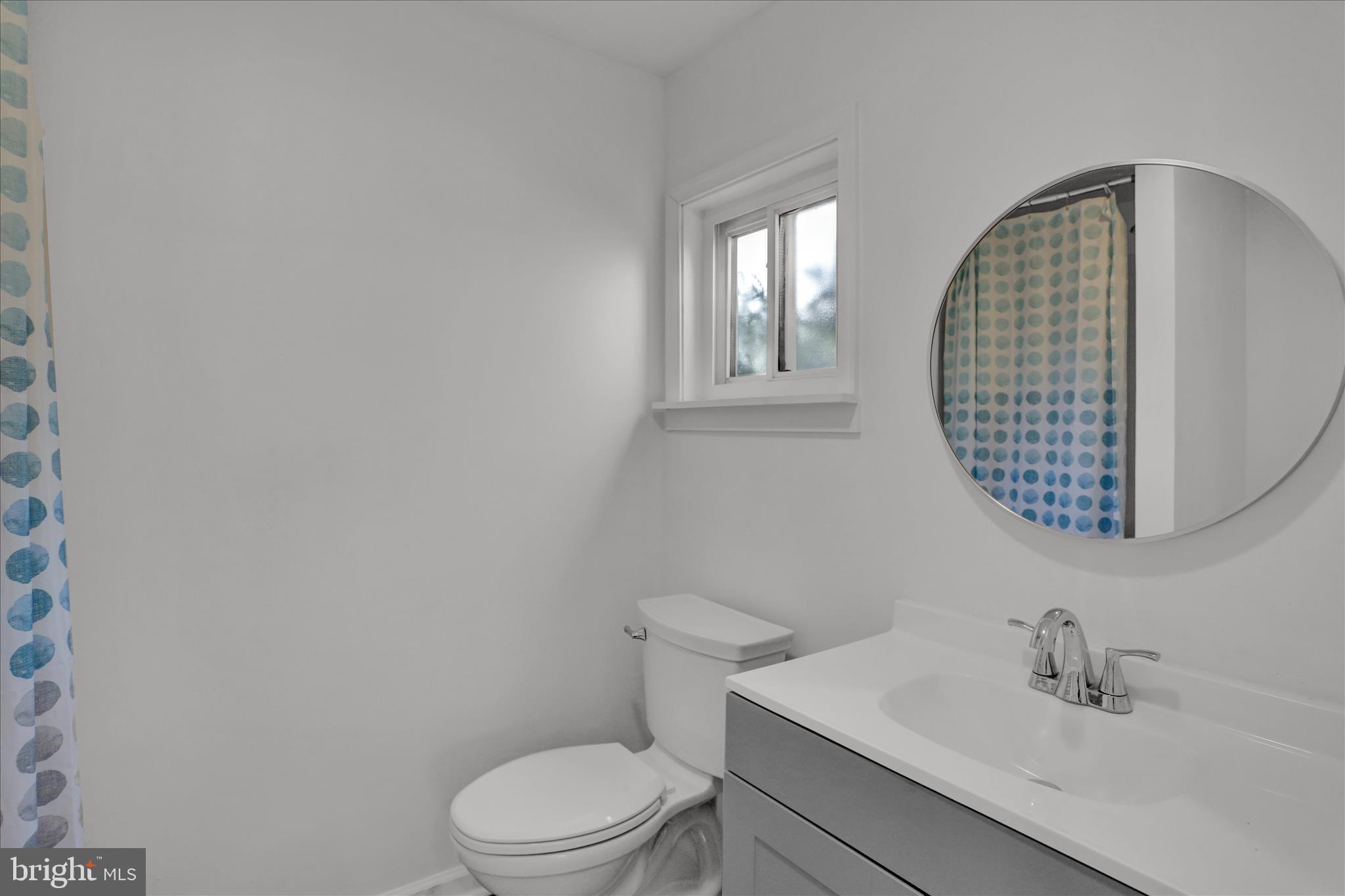 405 State Street Reading, PA 19607 - Photo 20 of 42 a bathroom with a toilet a sink and mirror