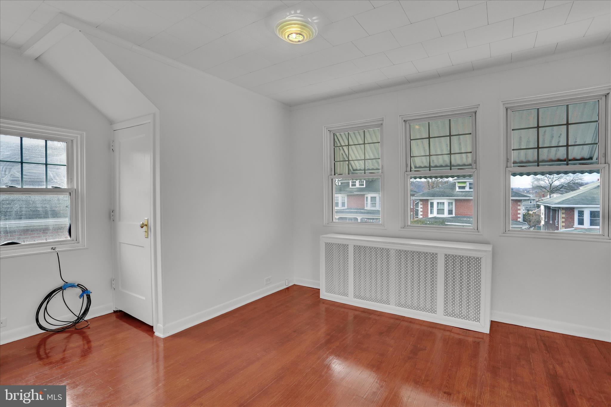 405 State Street Reading, PA 19607 - Photo 24 of 42 a view of an empty room with a window and wooden floor