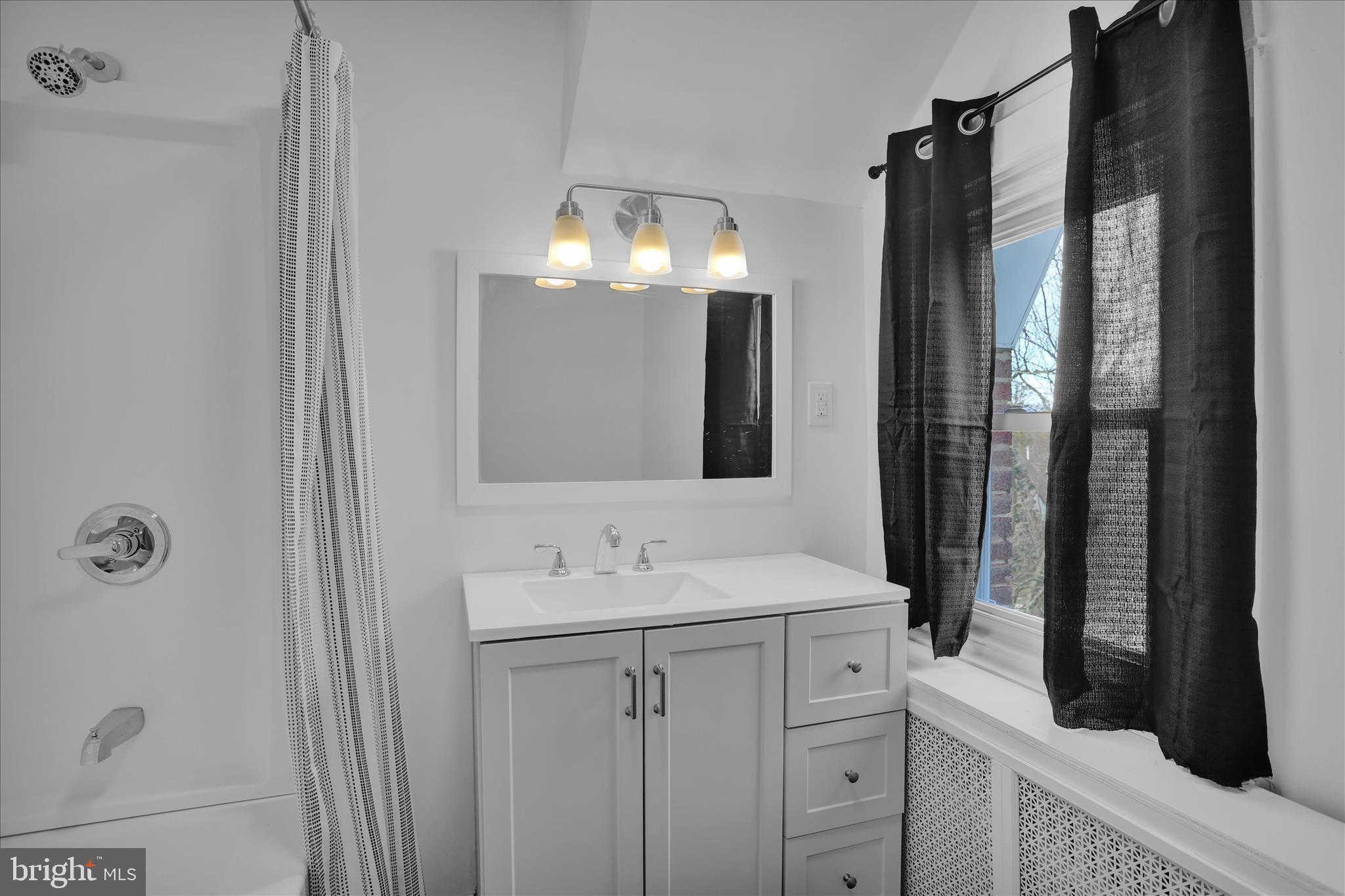 405 State Street Reading, PA 19607 - Photo 31 of 42 a bathroom with a double vanity sink and mirror