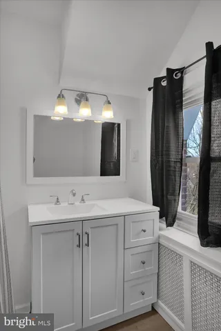 a bathroom with a double vanity sink and mirror