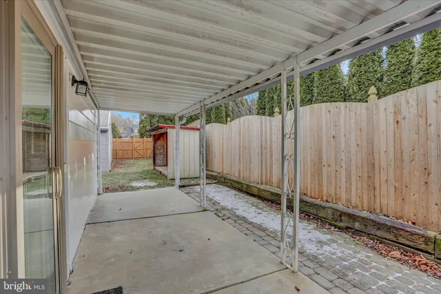 a view of a backyard with wooden fence