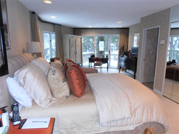 131 Deborah Road Newton, MA 02459 - Photo 8 of 12 a spacious bedroom with a bed a table and large windows