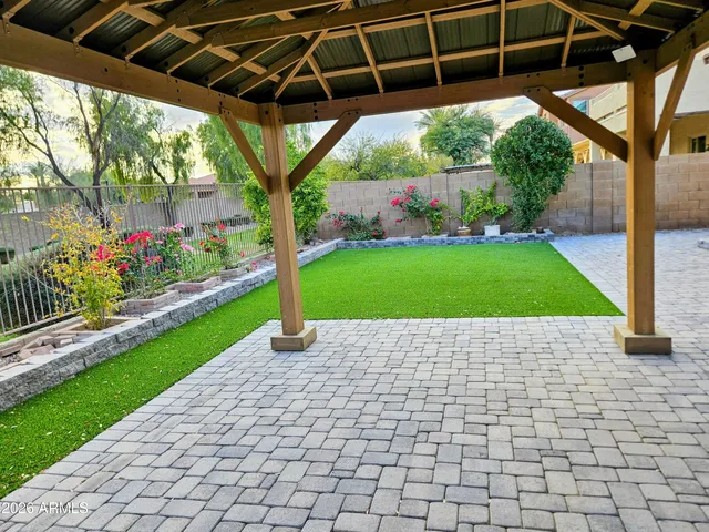 a kitchen with stainless steel appliances granite countertop a table chairs sink and cabinets