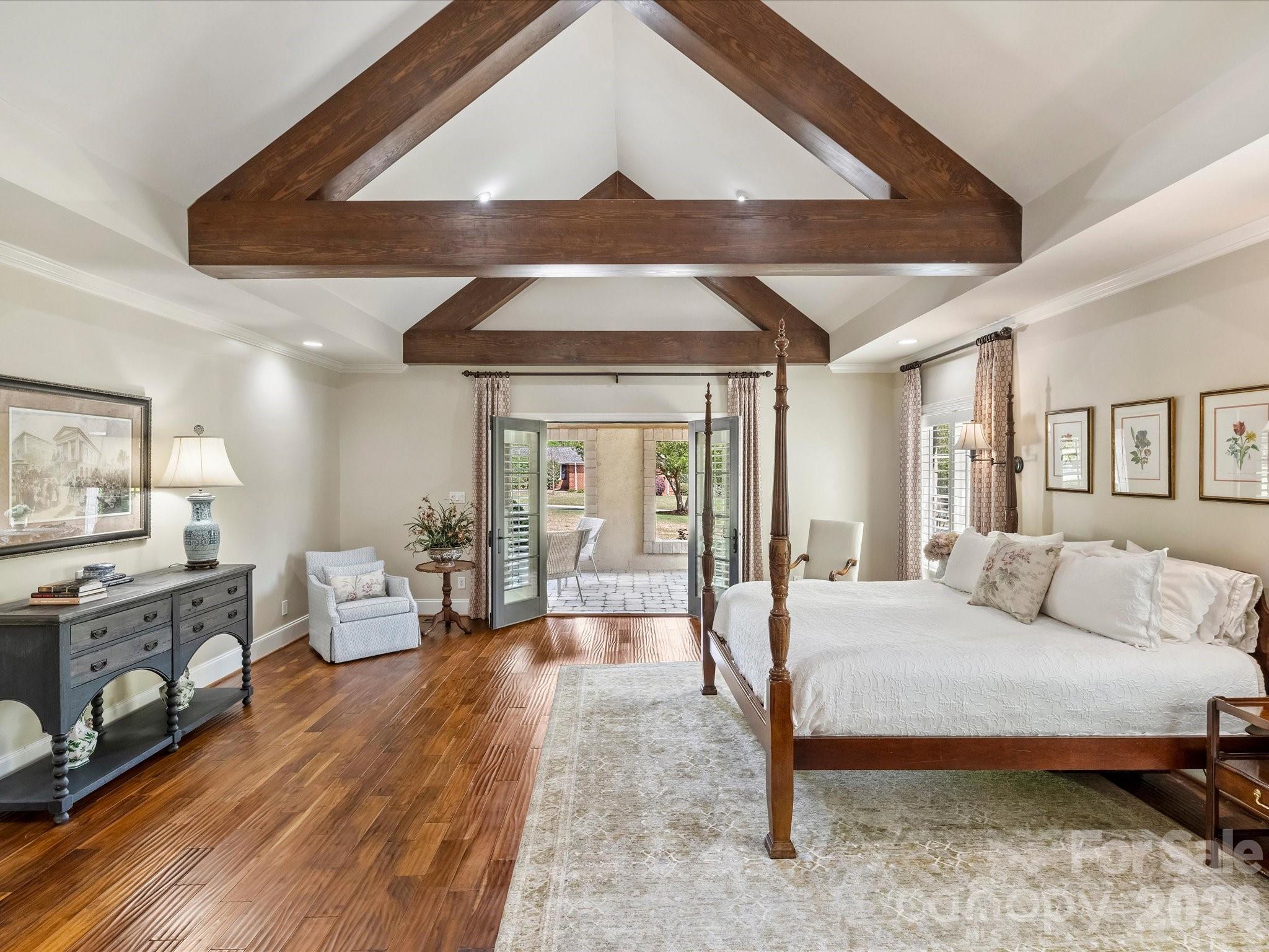 4330 Carmel Valley Road Charlotte, NC 28226 - Photo 16 of 38 a bedroom with a bed and wooden floor