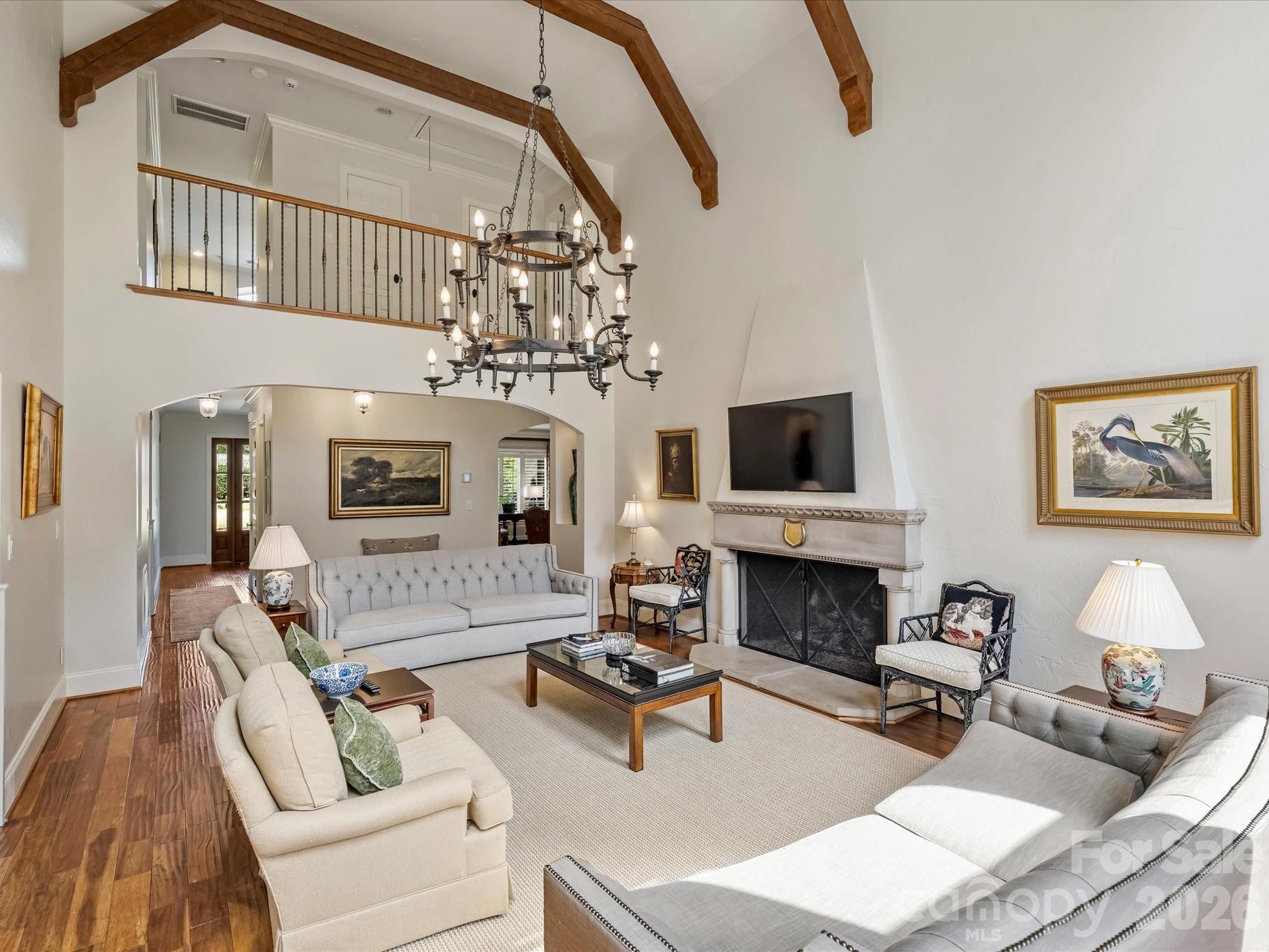 4330 Carmel Valley Road Charlotte, NC 28226 - Photo 8 of 38 a living room with furniture a fireplace and a chandelier