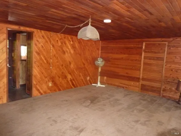 a bathroom with a granite countertop toilet sink and mirror
