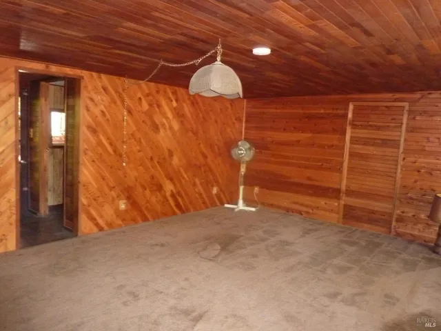 a bathroom with a granite countertop toilet sink and mirror