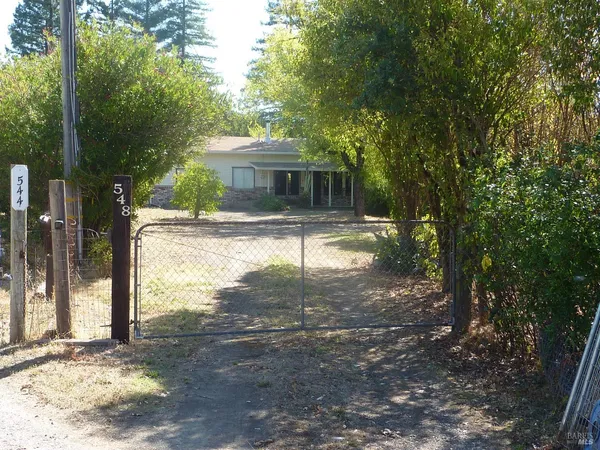 a view of a small yard in front of a house with a big yard