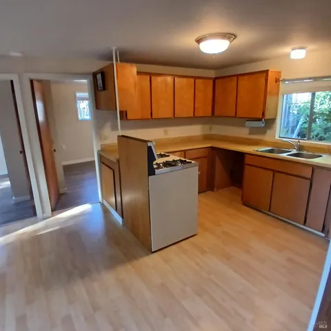 an empty room with kitchen space and appliances