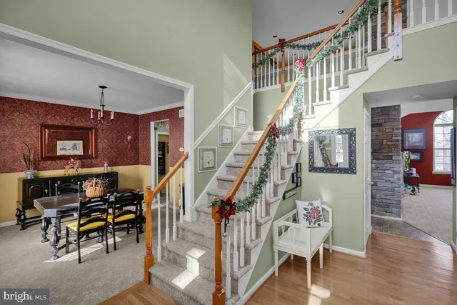 a view of entryway dining room and hall with wooden floor