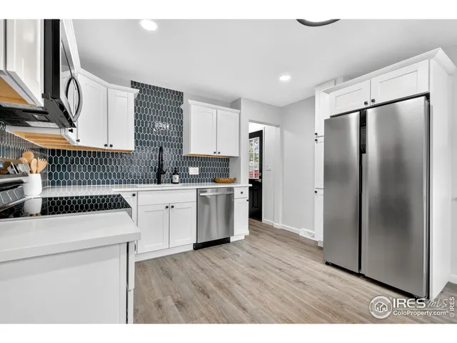 a kitchen with stainless steel appliances a refrigerator sink and cabinets