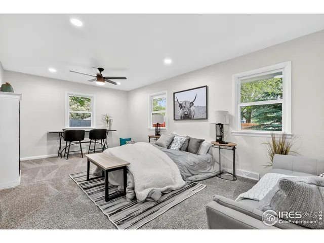 a view of a bedroom with furniture and windows