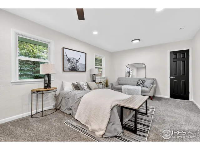 a bedroom with a large bed and a chandelier