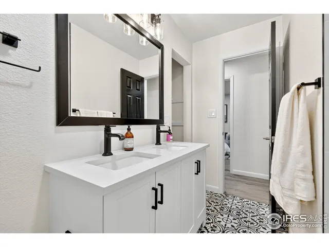 a bathroom with a sink a toilet and a window