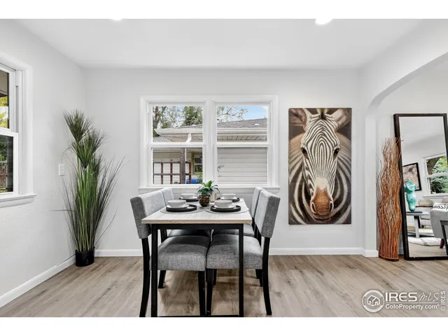 a dining room with furniture and window