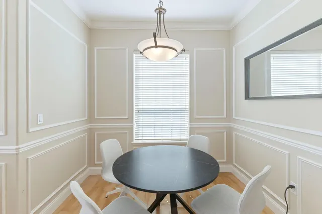 a dining room with furniture and window
