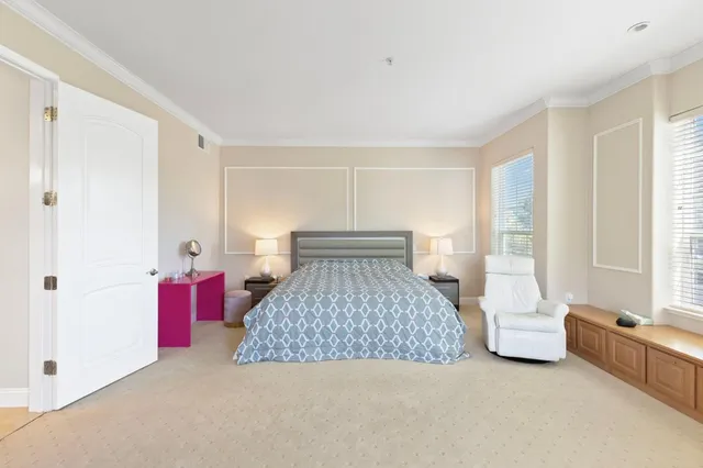 a bedroom with a bed and a large window