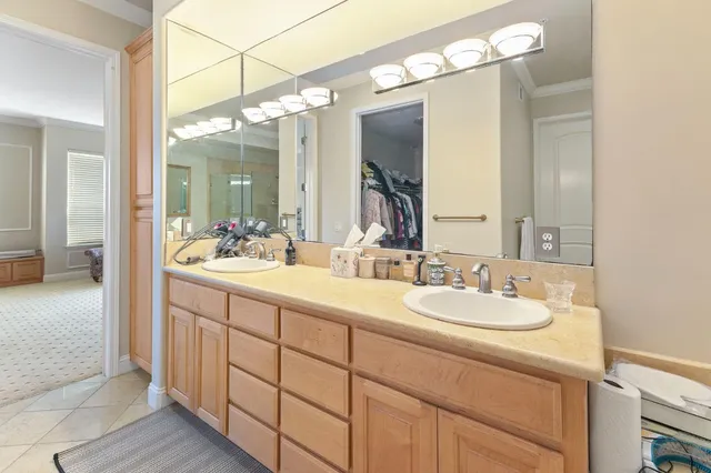 a bathroom with a double vanity sink and a mirror
