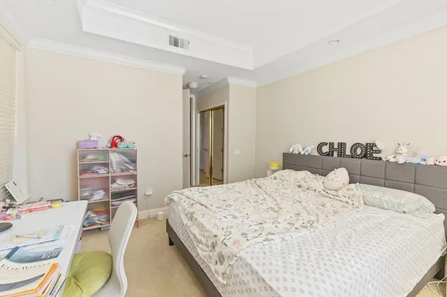 a bedroom with a bed and a table in it