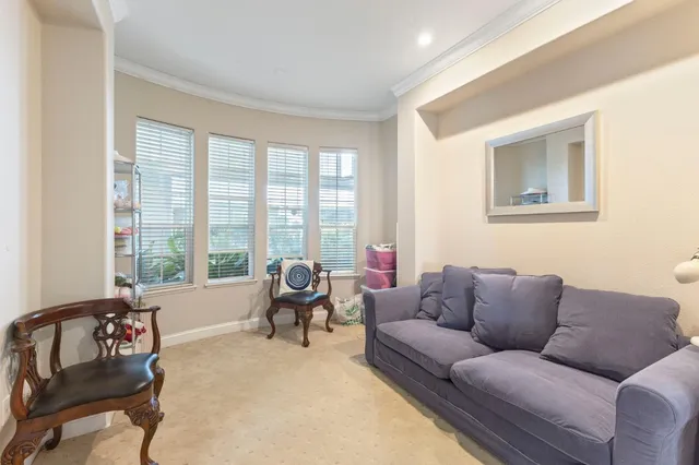 a living room with furniture and floor to ceiling windows