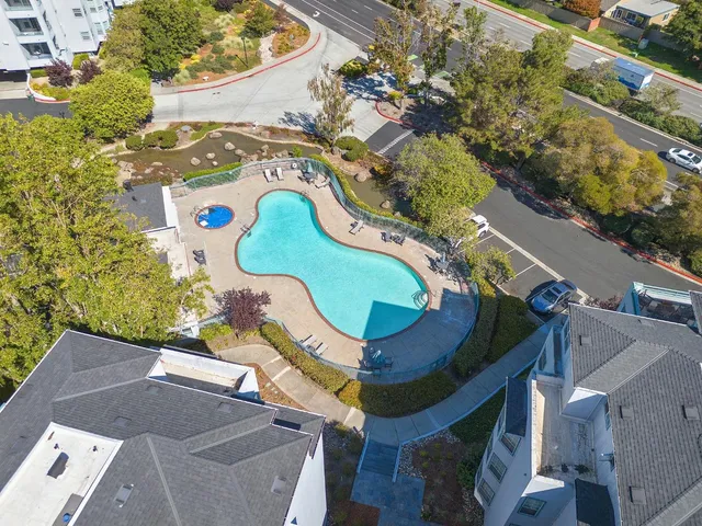 an aerial view of a house a swimming pool outdoor seating and yard