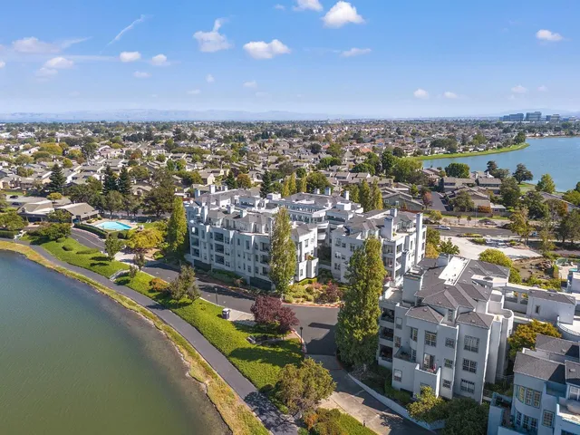 an aerial view of a house with a lake