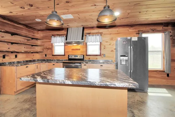a kitchen with refrigerator and window