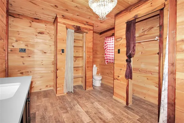 a view of a house with a big yard and large trees