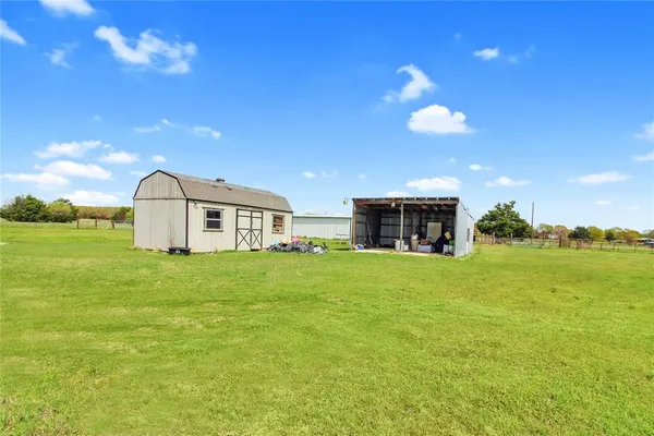 a view of a big yard with an outdoor space and seating area