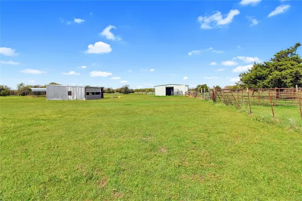 a view of field with grass and trees
