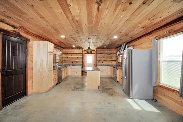 a kitchen with granite countertop a stove and a sink