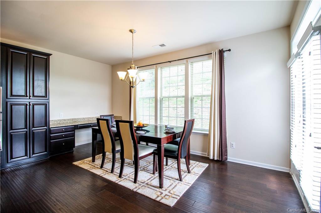 2279 Drake Mill Lane Southwest Concord, NC 28025 - Photo 12 of 40 a view of a dining room with furniture window and wooden floor