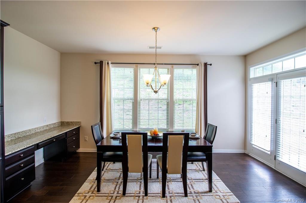 2279 Drake Mill Lane Southwest Concord, NC 28025 - Photo 13 of 40 a view of a dining room with furniture window and wooden floor