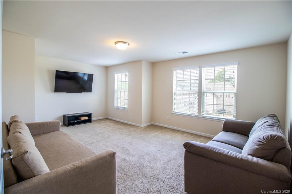2279 Drake Mill Lane Southwest Concord, NC 28025 - Photo 19 of 40 a living room with furniture and a flat screen tv