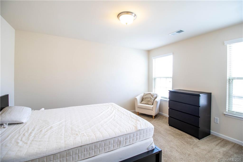 2279 Drake Mill Lane Southwest Concord, NC 28025 - Photo 20 of 40 a bedroom with a bed and a window
