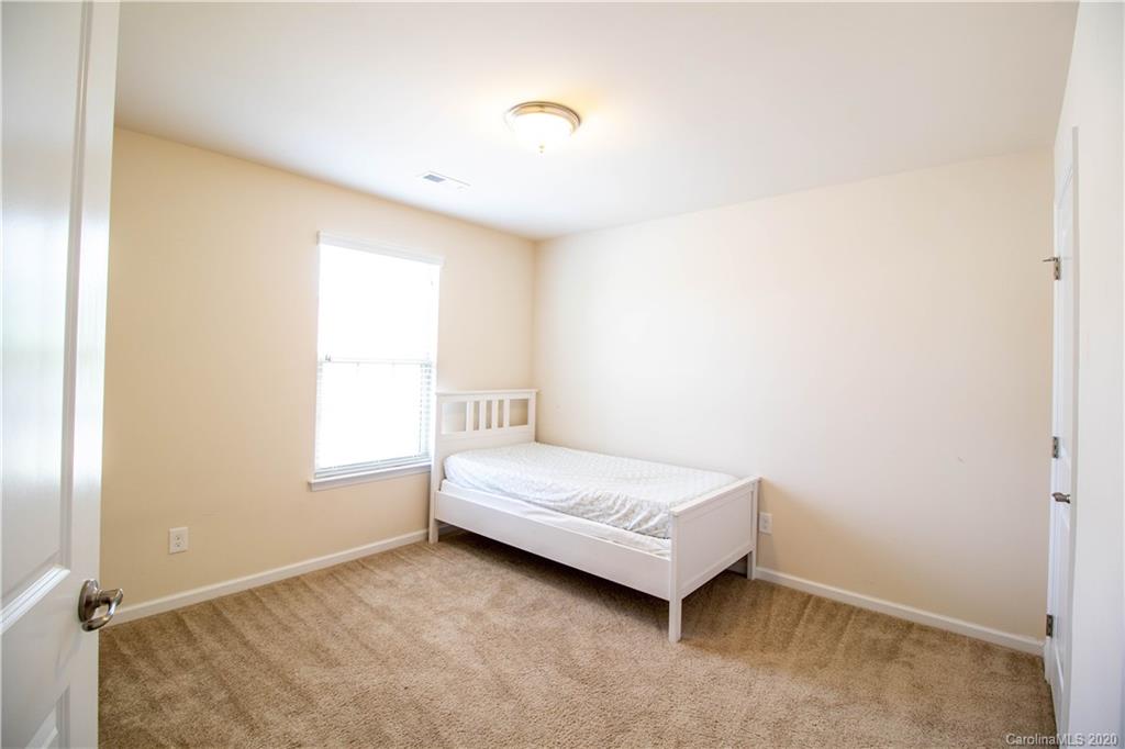 2279 Drake Mill Lane Southwest Concord, NC 28025 - Photo 21 of 40 a room with a bed and a window