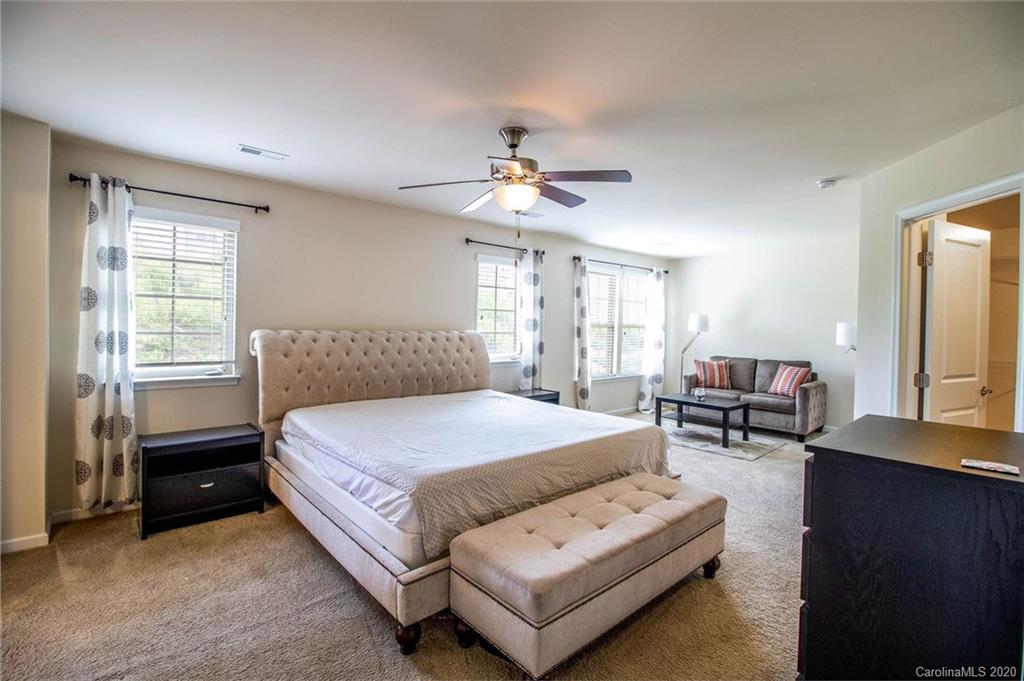 2279 Drake Mill Lane Southwest Concord, NC 28025 - Photo 22 of 40 a spacious bedroom with a bed and window