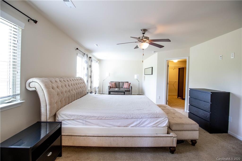2279 Drake Mill Lane Southwest Concord, NC 28025 - Photo 23 of 40 a spacious bedroom with a bed and furniture