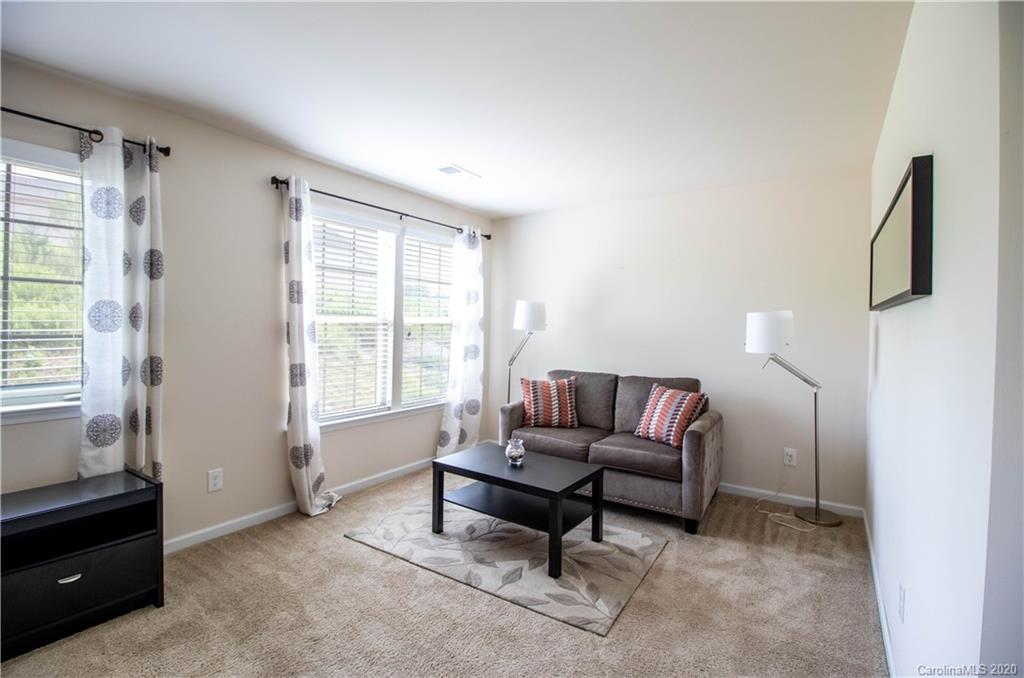 2279 Drake Mill Lane Southwest Concord, NC 28025 - Photo 24 of 40 a living room with furniture and a window