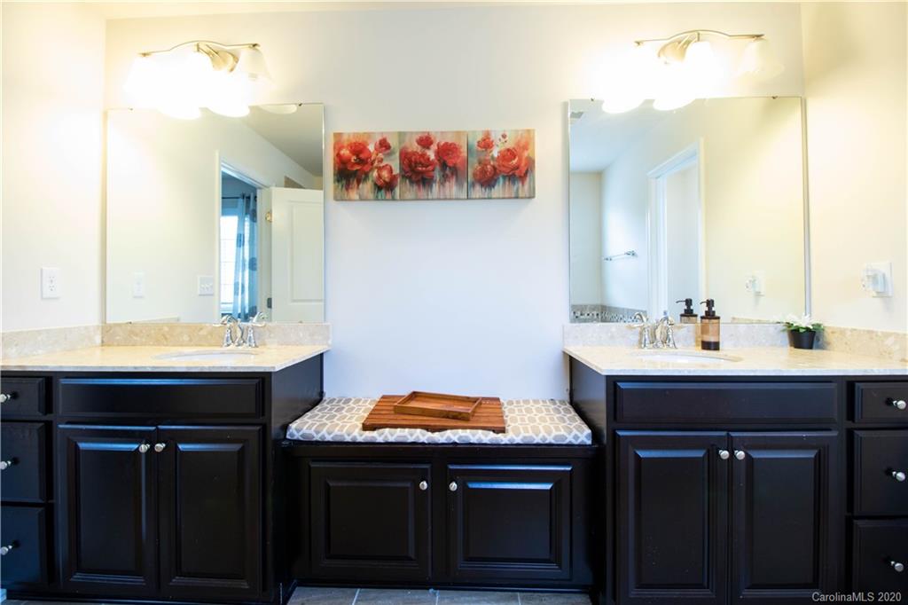2279 Drake Mill Lane Southwest Concord, NC 28025 - Photo 27 of 40 a bathroom with a sink and a mirror