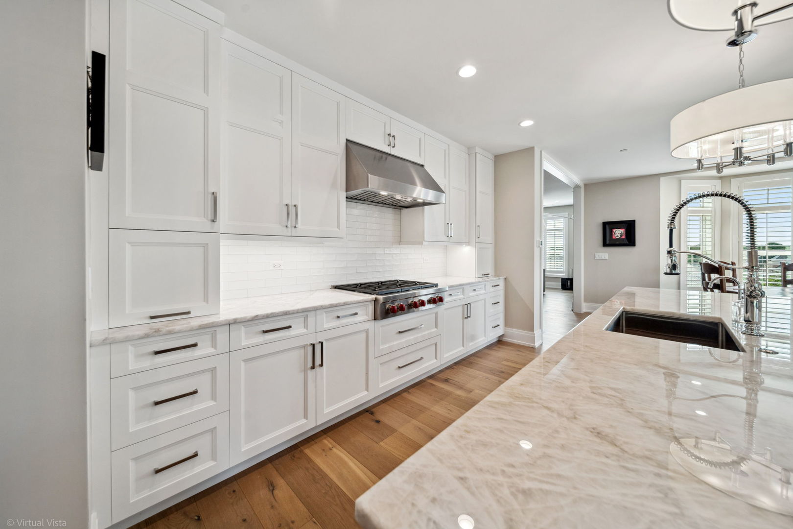 110 South Washington Street, Unit 400 Naperville, IL 60540 - Photo 13 of 34 a kitchen with stainless steel appliances a sink dishwasher and white cabinets with wooden floor