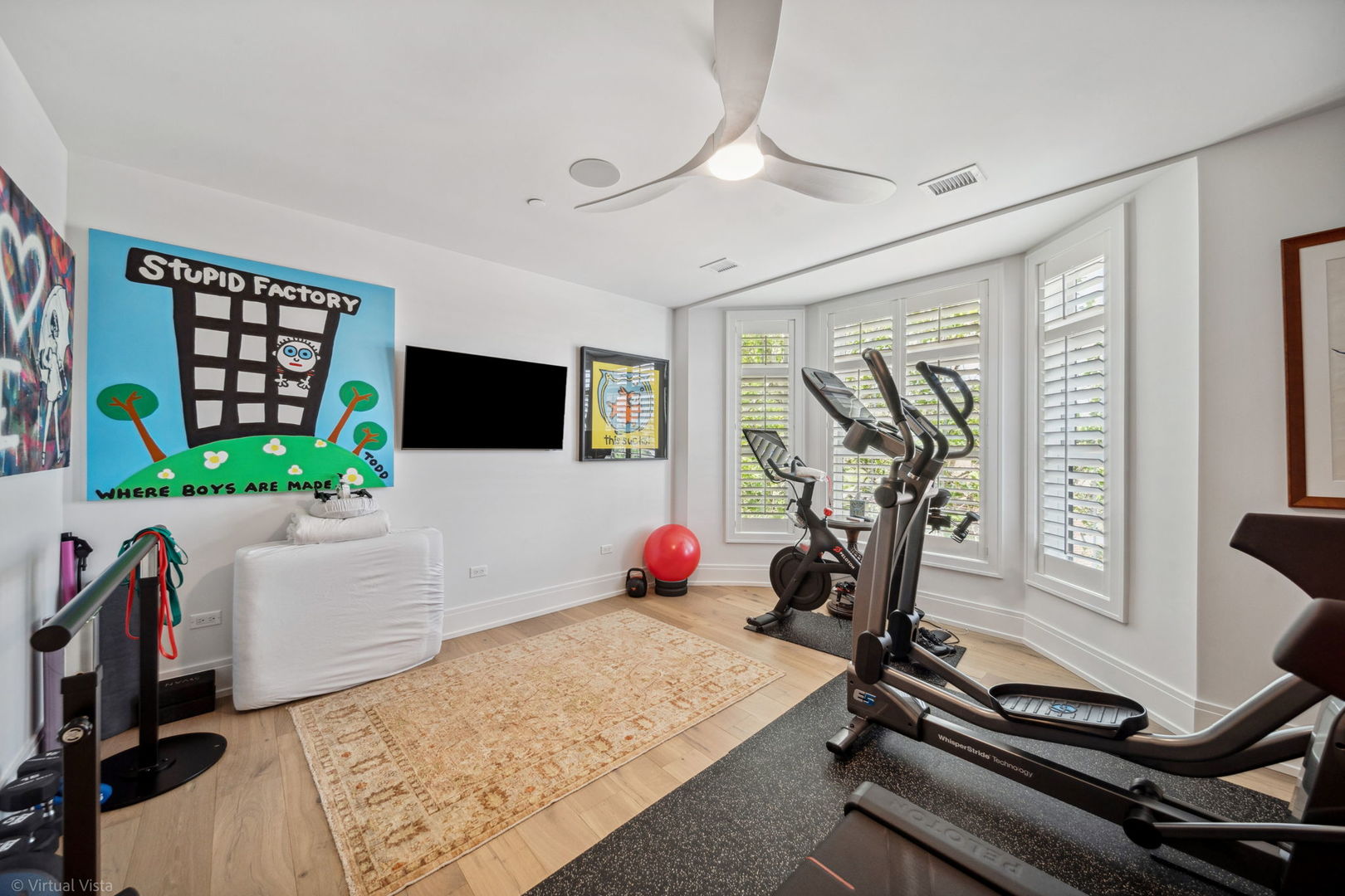 110 South Washington Street, Unit 400 Naperville, IL 60540 - Photo 22 of 34 a room with gym equipment and a flat screen tv