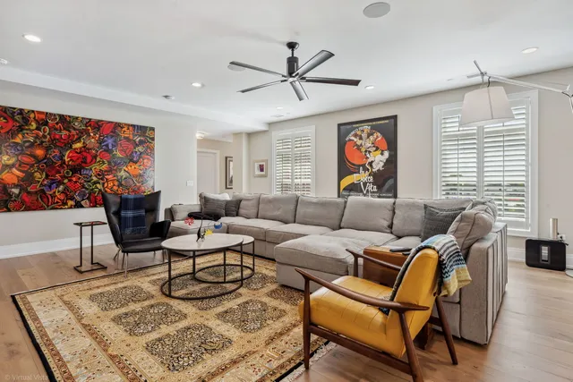 a living room with furniture a rug and a window
